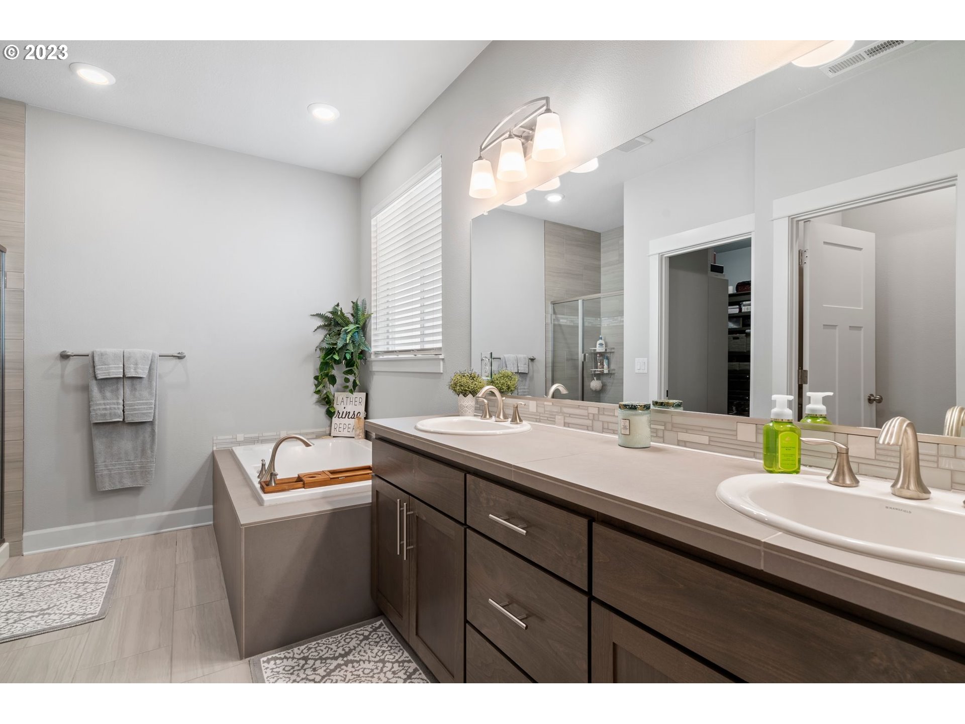 4805 South 17th Way Ridgefield, WA 98642 - Photo 17 of 33 a bathroom with a sink double vanity and a bathtub
