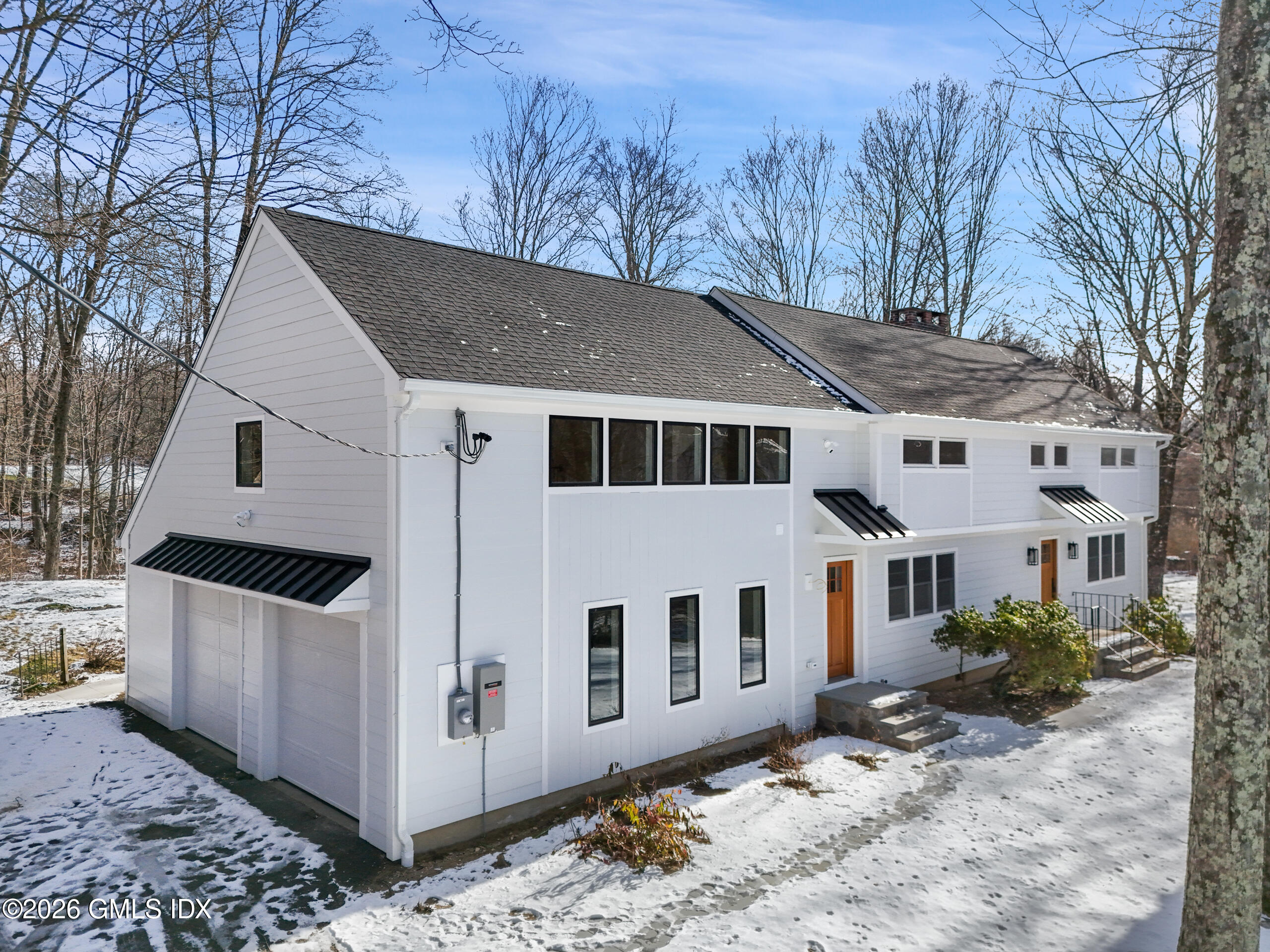 a view of a white house with a large window