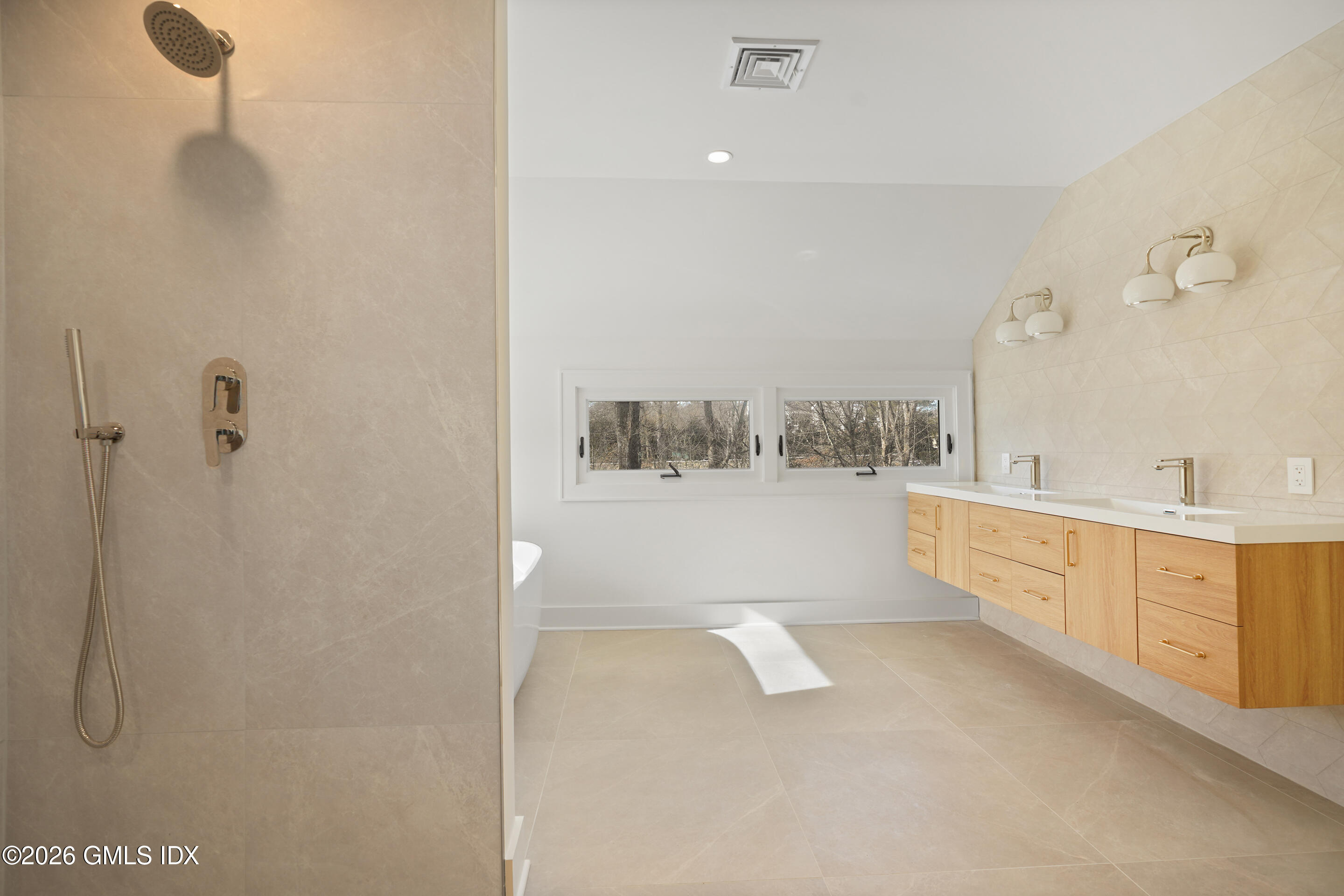 403 Stanwich Road Greenwich, CT 06830 - Photo 20 of 31 a large bathroom with a tub sink and mirror