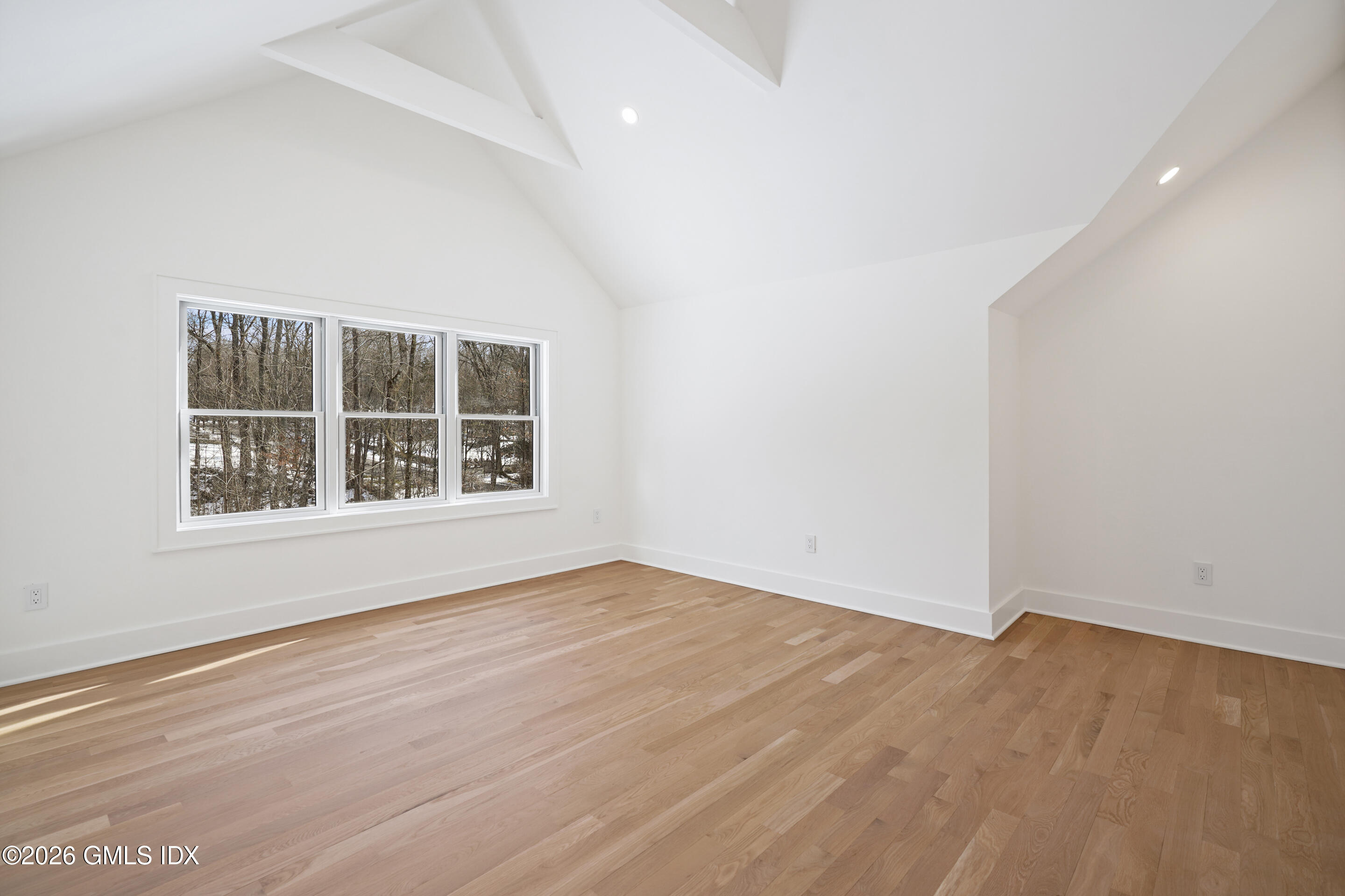 403 Stanwich Road Greenwich, CT 06830 - Photo 22 of 31 an empty room with wooden floor and windows