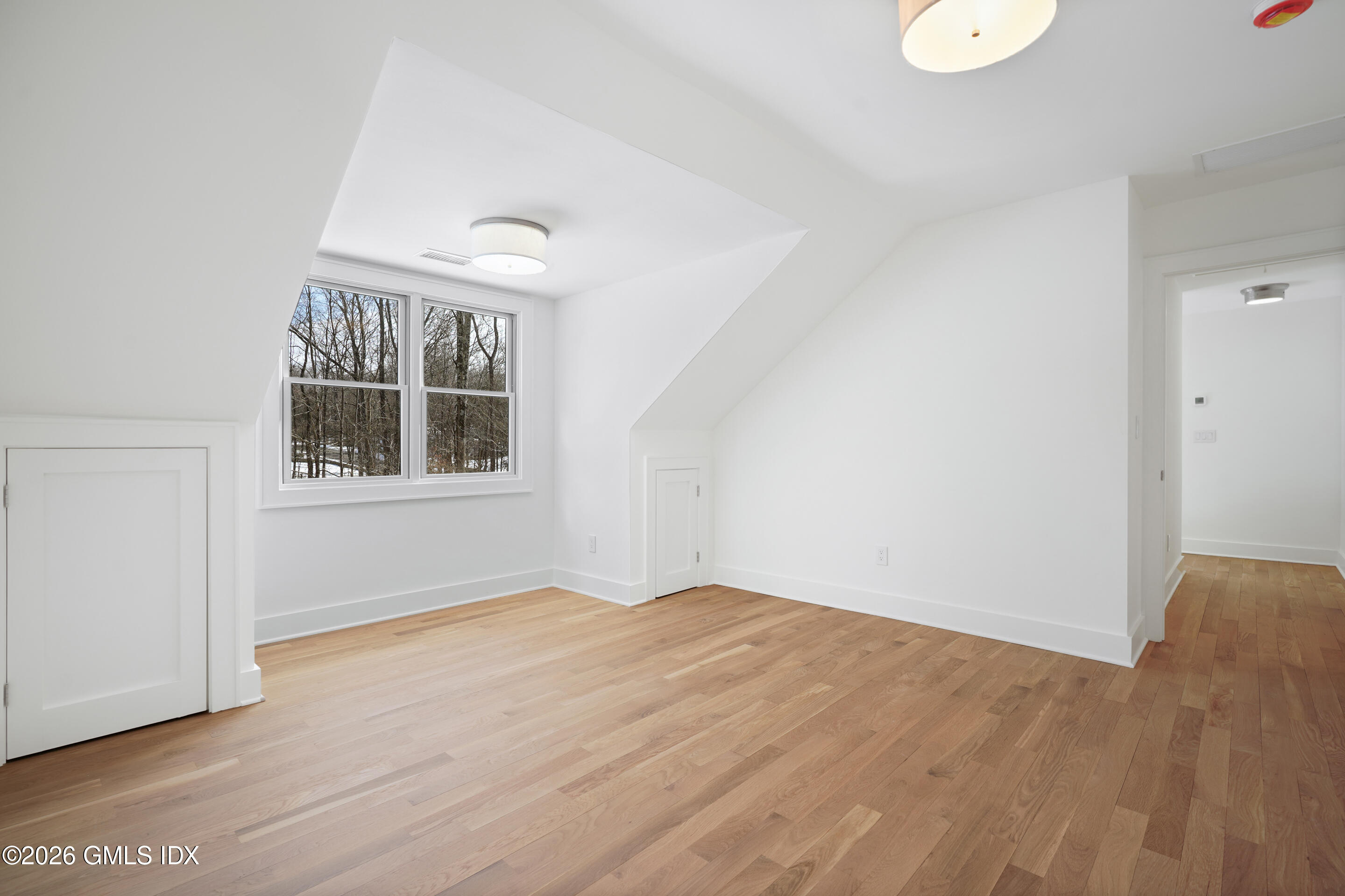 403 Stanwich Road Greenwich, CT 06830 - Photo 26 of 31 an empty room with wooden floor and windows