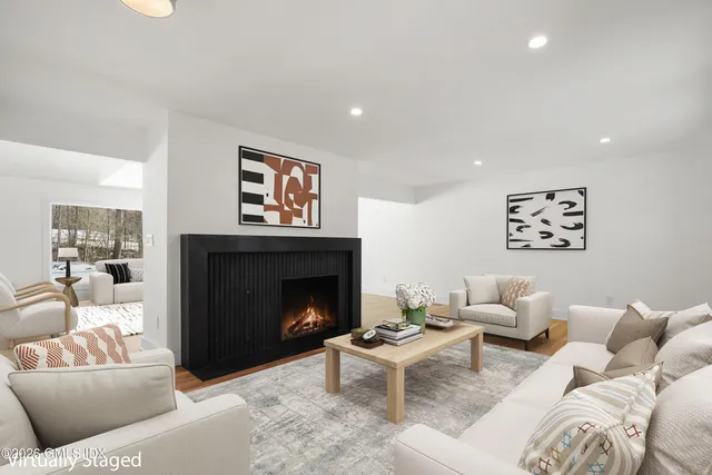 a living room with furniture and a fireplace