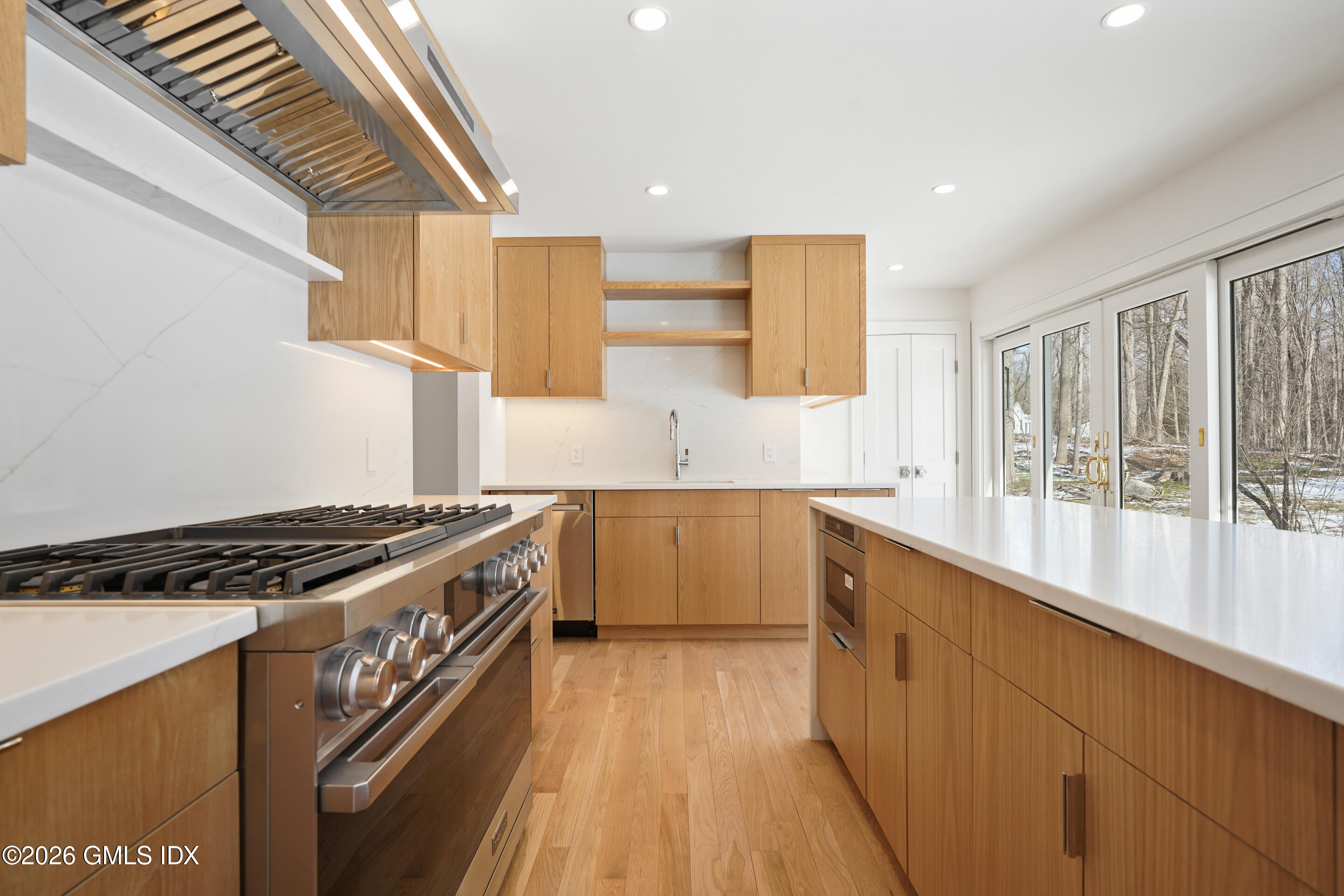 403 Stanwich Road Greenwich, CT 06830 - Photo 8 of 31 a kitchen with stainless steel appliances granite countertop a stove a sink and a refrigerator
