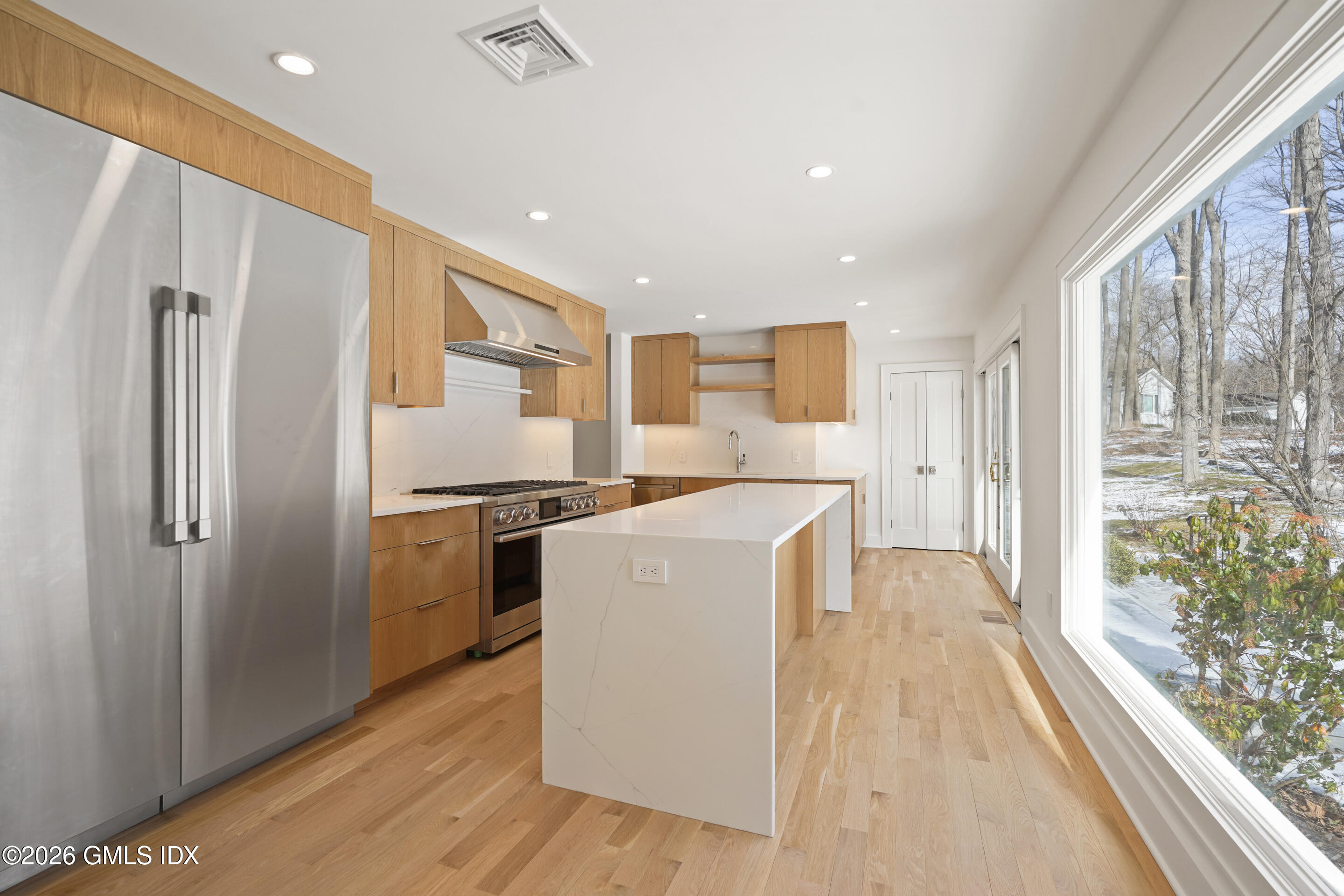403 Stanwich Road Greenwich, CT 06830 - Photo 10 of 31 a kitchen with a refrigerator a stove top oven and a large window