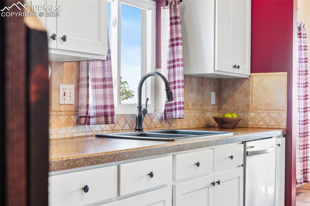 16145 Turftop Terrace Elbert, CO 80106 - Photo 11 of 29 a kitchen with granite countertop white cabinets and white appliances