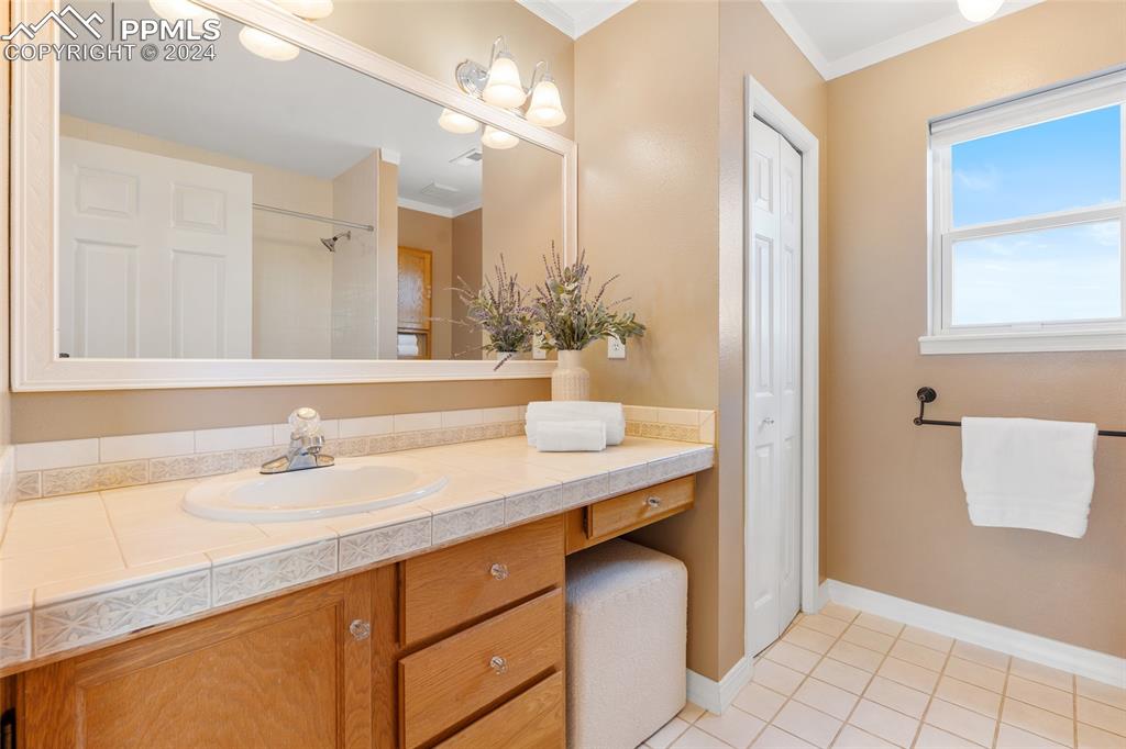 16145 Turftop Terrace Elbert, CO 80106 - Photo 17 of 29 a bathroom with a sink a vanity and a mirror