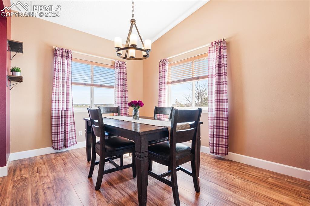 16145 Turftop Terrace Elbert, CO 80106 - Photo 6 of 29 a view of a dining room with furniture window and wooden floor
