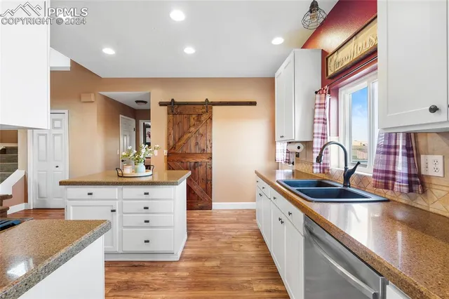 a kitchen with stainless steel appliances granite countertop a refrigerator and a stove