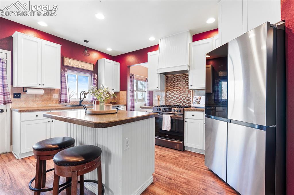16145 Turftop Terrace Elbert, CO 80106 - Photo 8 of 29 a kitchen with stainless steel appliances granite countertop a refrigerator and a stove