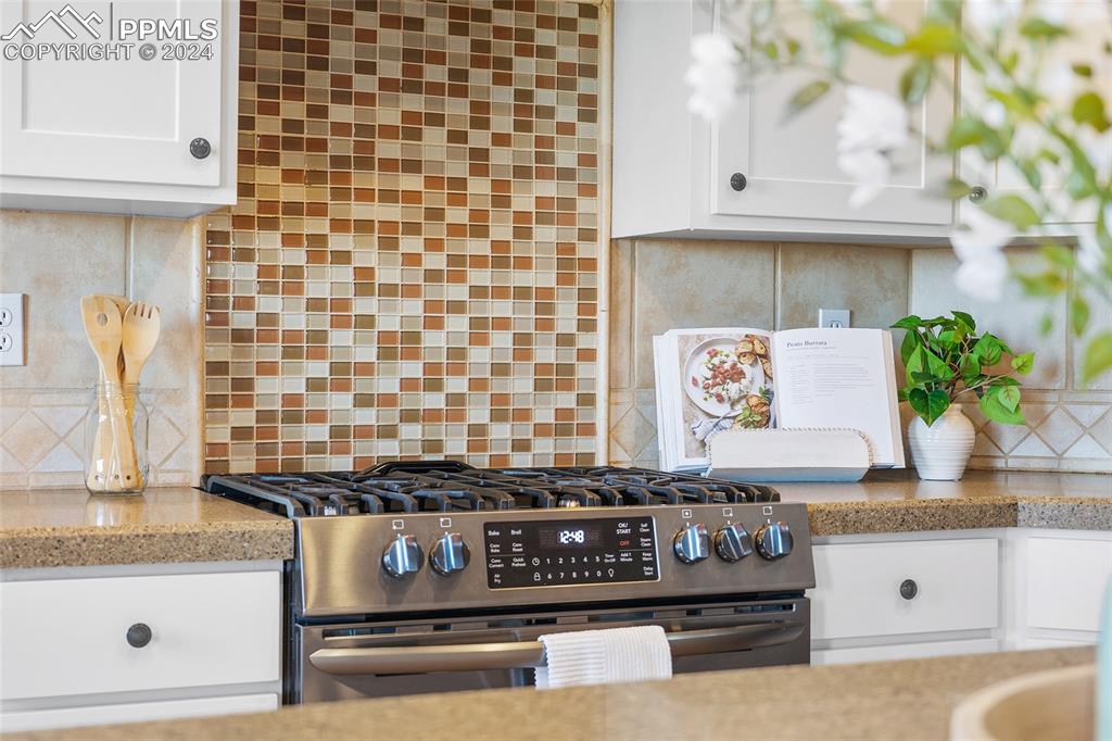 16145 Turftop Terrace Elbert, CO 80106 - Photo 9 of 29 a kitchen with granite countertop white cabinets and stainless steel appliances
