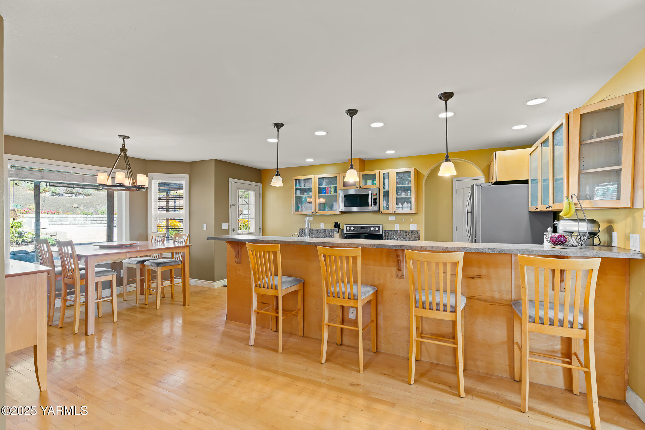 620 Tibbling Road Selah, WA 98942 - Photo 14 of 60 a dining hall with stainless steel appliances a dining table and chairs with wooden floor