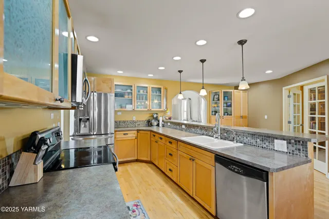 a bathroom with a granite countertop toilet sink and mirror