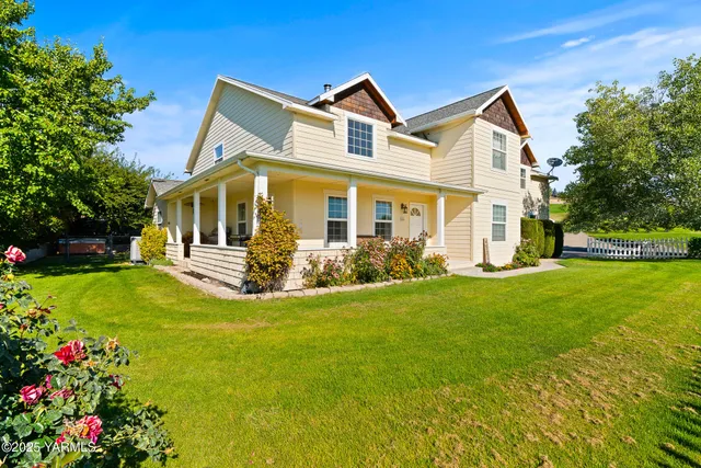 a front view of a house with a garden and yard