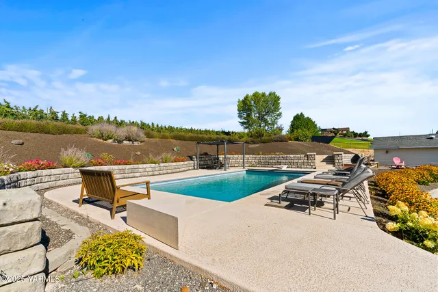 an aerial view of residential houses with outdoor space and river