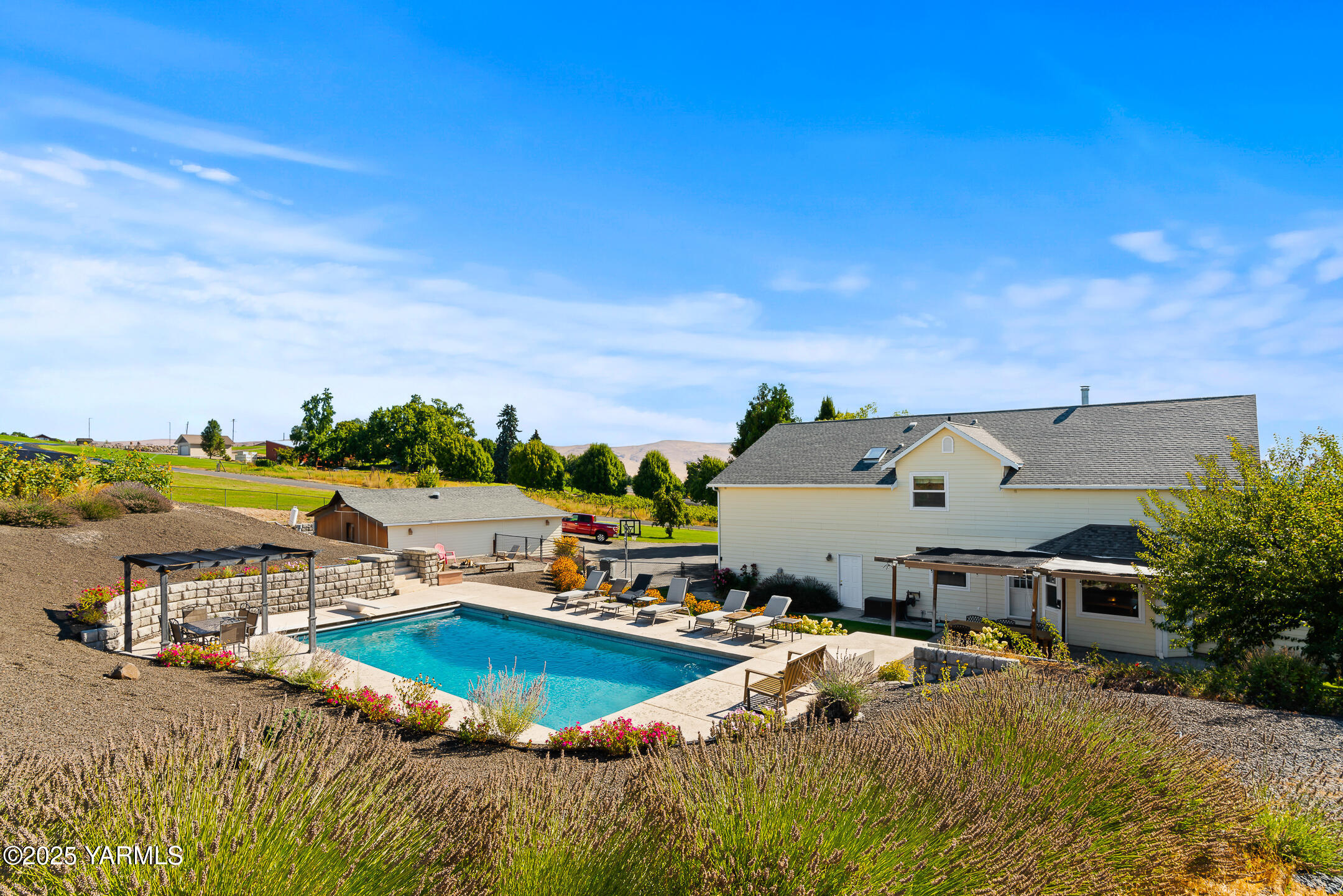 620 Tibbling Road Selah, WA 98942 - Photo 47 of 60 an aerial view of a house with swimming pool and lake view