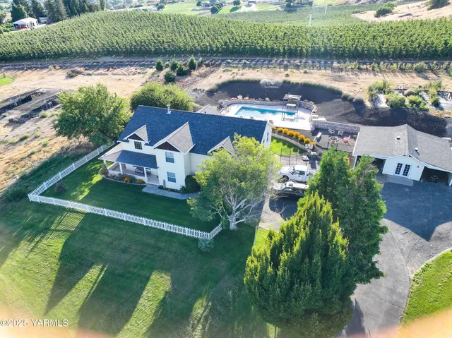 an aerial view of a house with garden space and street view