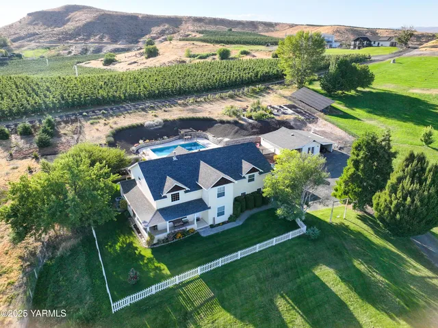 an aerial view of a house with garden space and lake view