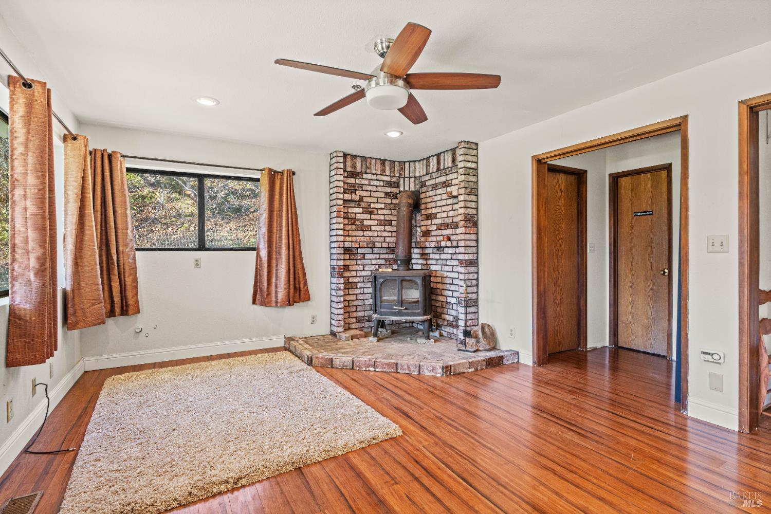 6620 Robinson Creek Road Ukiah, CA 95482 - Photo 20 of 47 an empty room with wooden floor and windows