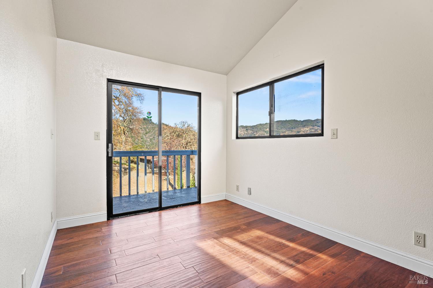 6620 Robinson Creek Road Ukiah, CA 95482 - Photo 33 of 47 an empty room with wooden floor and windows