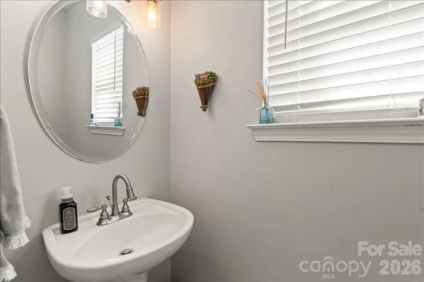 a bathroom with a sink a mirror and a window