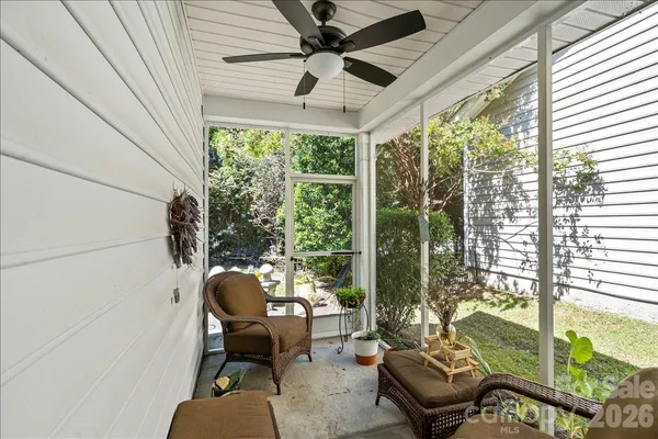 a balcony with furniture and a potted plant