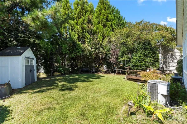 a view of backyard with swimming pool