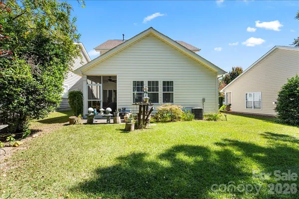 a view of a house with backyard porch and sitting area
