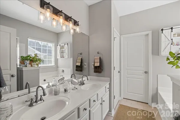 a bathroom with a double vanity sink and a mirror