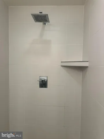 a white toilet sitting next to a bathroom sink and vanity