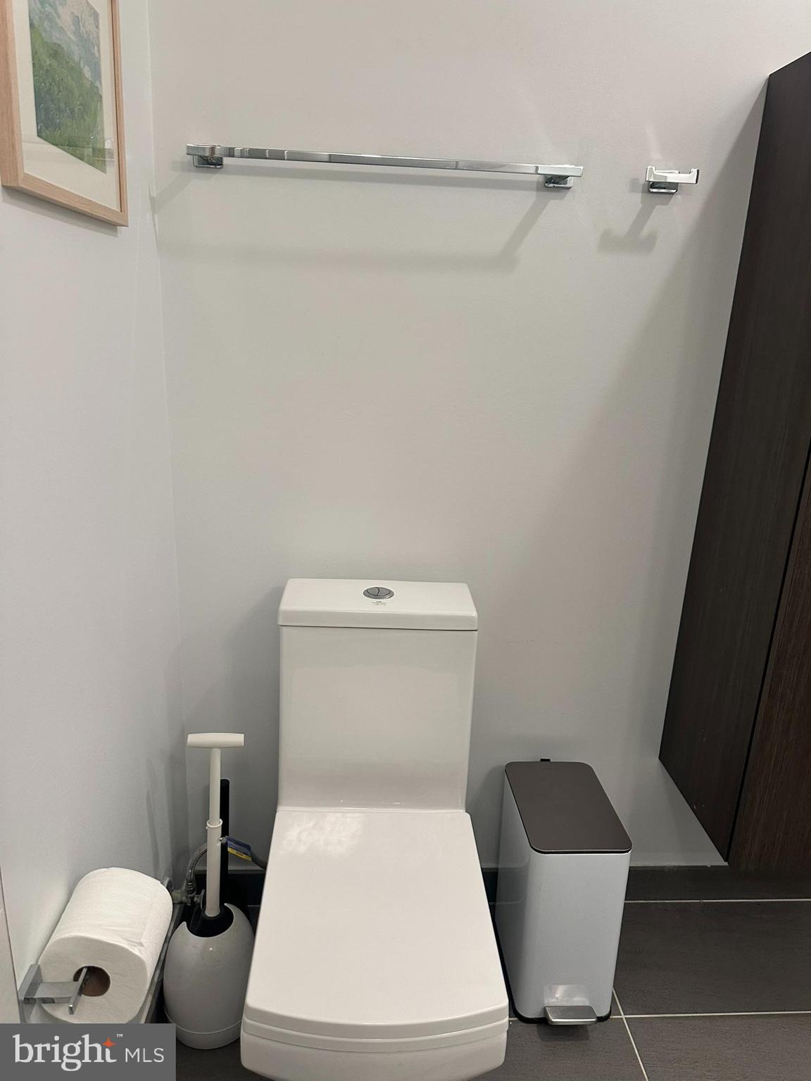 1837 Kalorama Road Northwest, Unit B Washington, DC 20009 - Photo 16 of 45 a white toilet sitting next to a bathroom sink and vanity