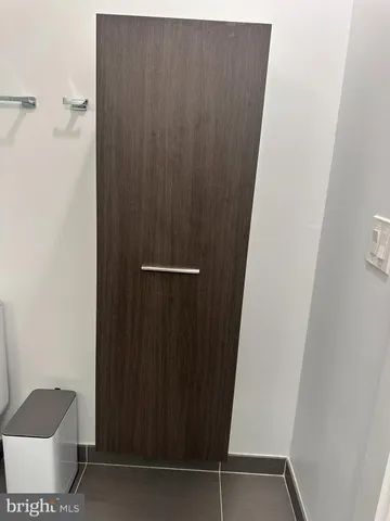 a large kitchen with stainless steel appliances granite countertop a large counter top and a wooden floor