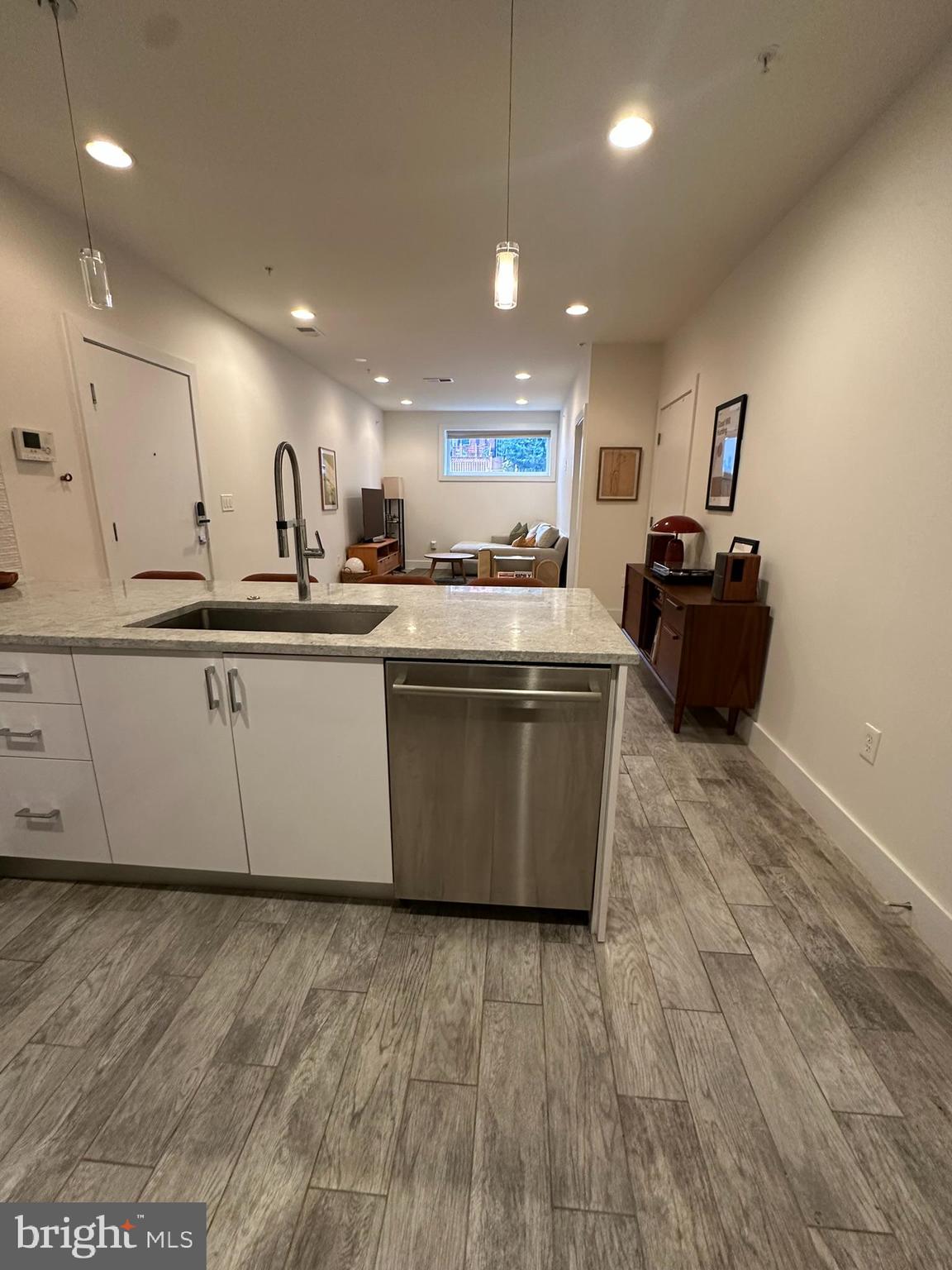 1837 Kalorama Road Northwest, Unit B Washington, DC 20009 - Photo 19 of 45 a large kitchen with stainless steel appliances granite countertop a large counter top and a wooden floor