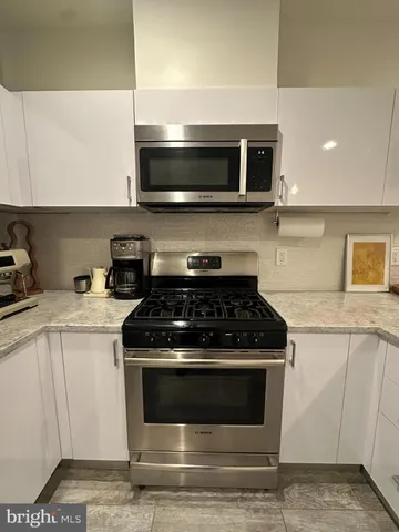 a kitchen with a sink stove and microwave