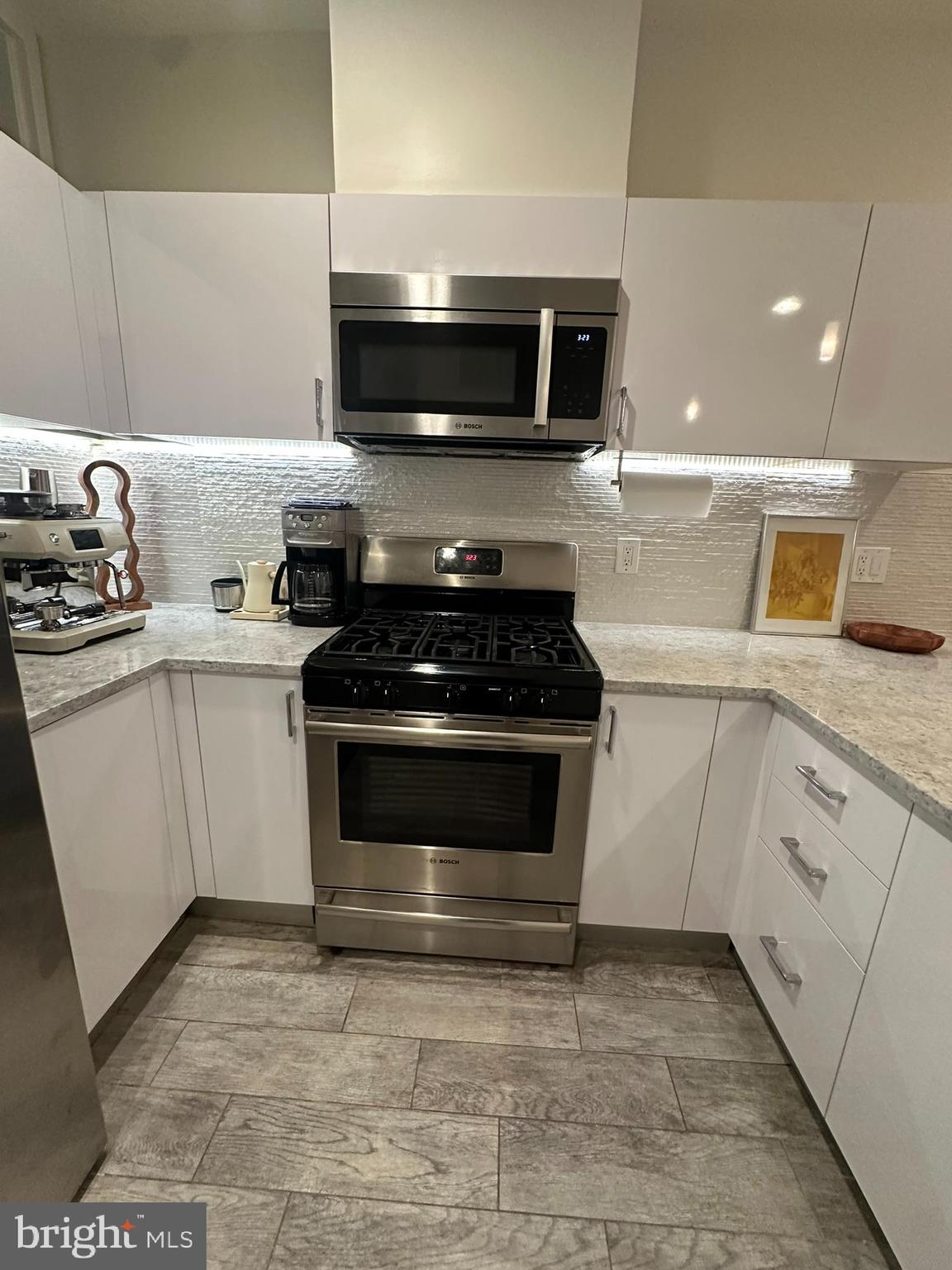 1837 Kalorama Road Northwest, Unit B Washington, DC 20009 - Photo 22 of 45 a kitchen with a sink stove and microwave