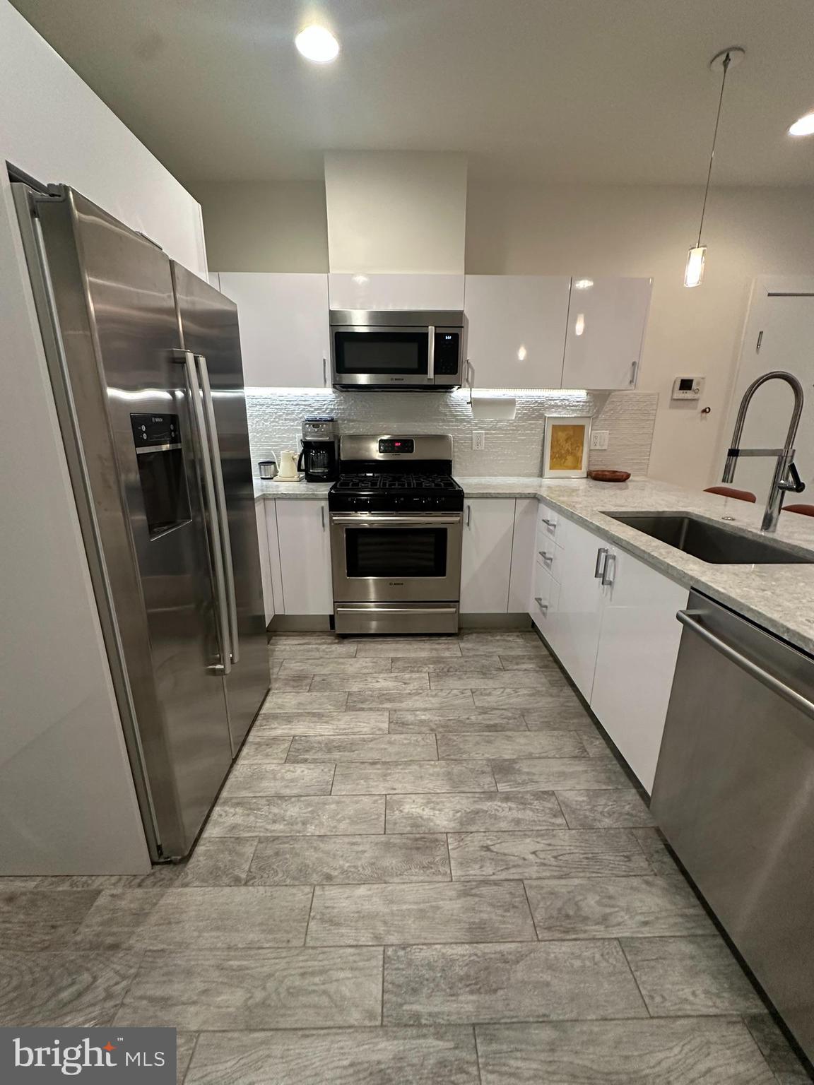 1837 Kalorama Road Northwest, Unit B Washington, DC 20009 - Photo 23 of 45 a large kitchen with stainless steel appliances and a sink