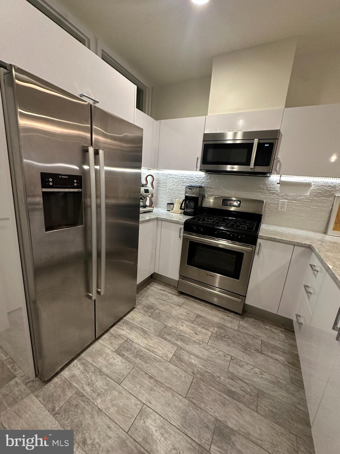 1837 Kalorama Road Northwest, Unit B Washington, DC 20009 - Photo 24 of 45 a kitchen with stainless steel appliances granite countertop a refrigerator and a stove