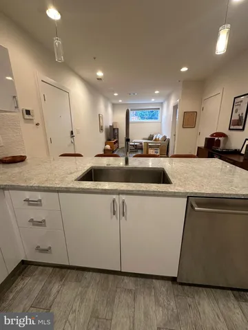 a kitchen with kitchen island a counter top space cabinets and appliances
