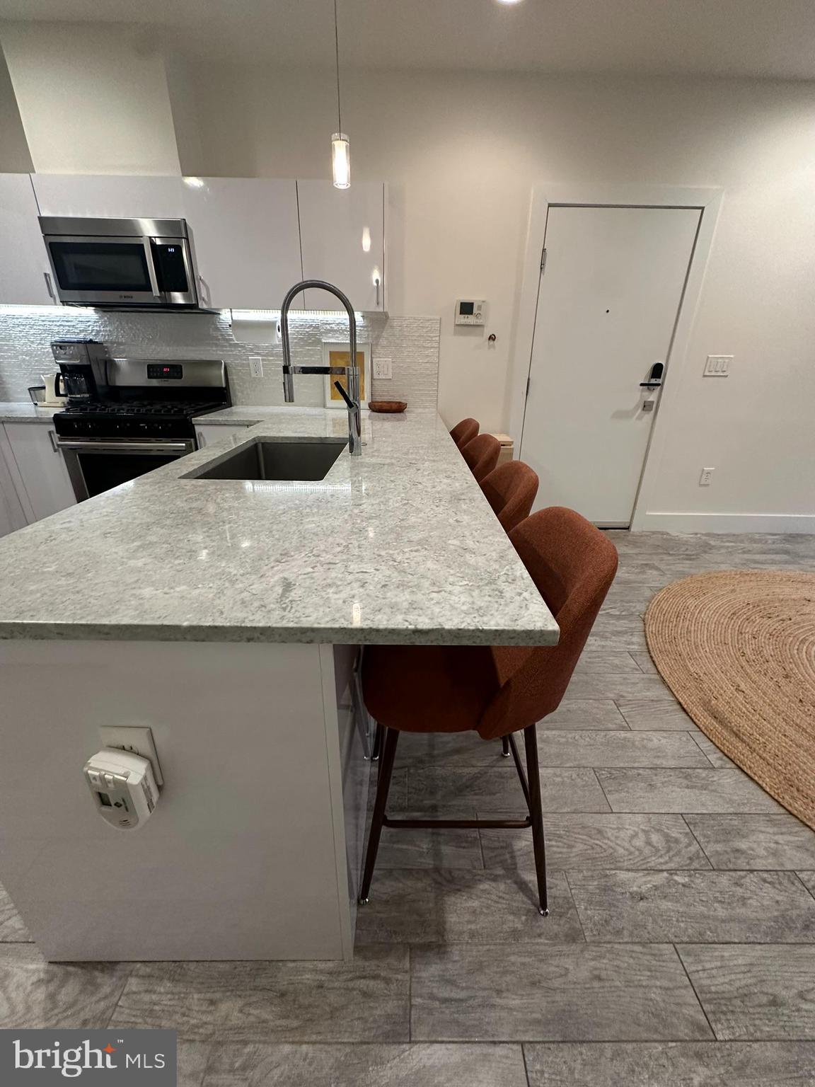 1837 Kalorama Road Northwest, Unit B Washington, DC 20009 - Photo 27 of 45 a kitchen with kitchen island a counter top space cabinets and appliances