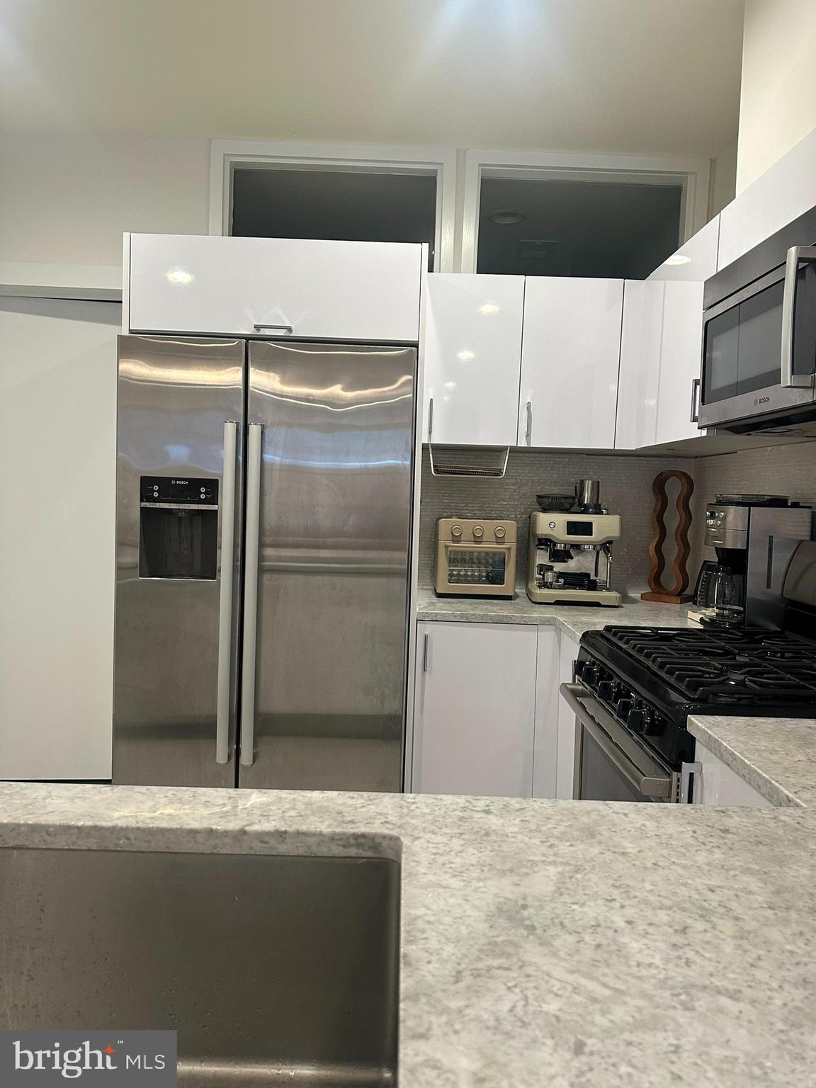 1837 Kalorama Road Northwest, Unit B Washington, DC 20009 - Photo 29 of 45 a kitchen with stainless steel appliances a refrigerator a stove a sink and dishwasher