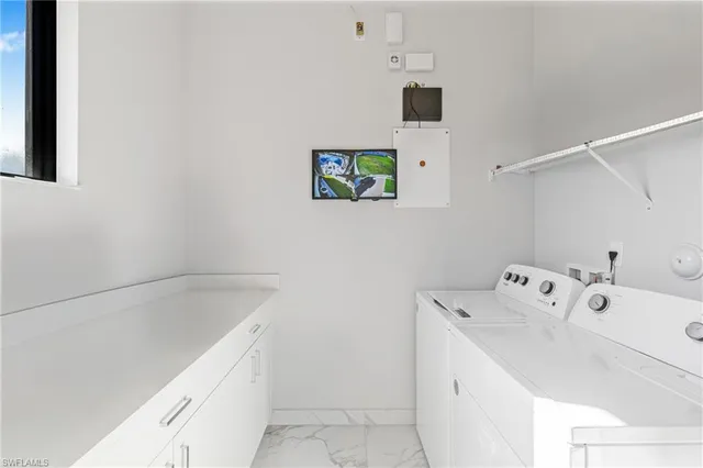 a utility room with a sink dryer and washer