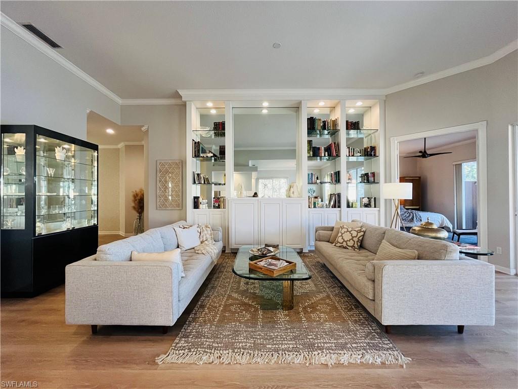 5477 Freeport Lane Naples, FL 34119 - Photo 6 of 36 a living room with furniture and a large window
