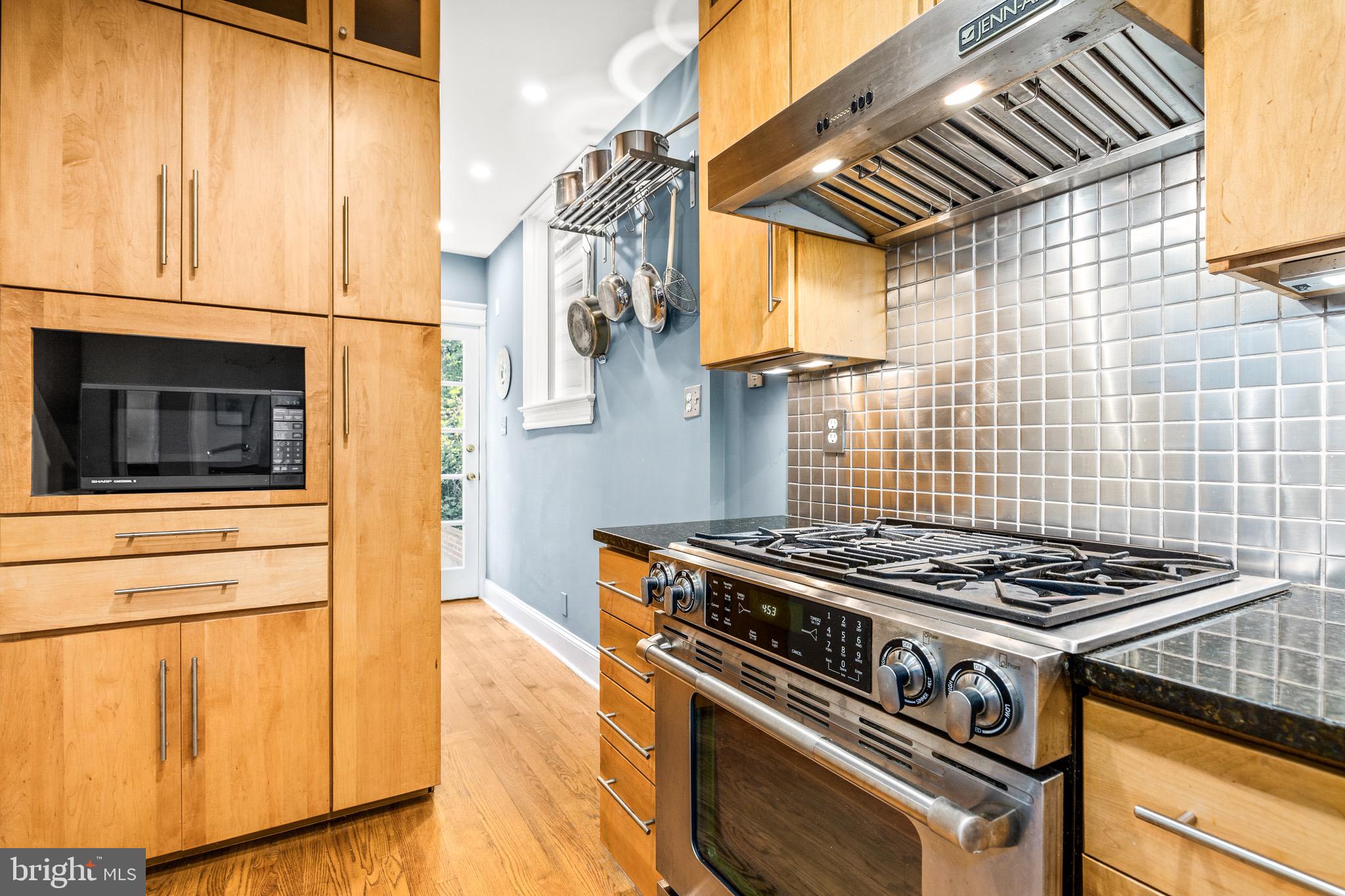 1716 Irving Street Northwest Washington, DC 20010 - Photo 13 of 43 a kitchen with a stove and a microwave