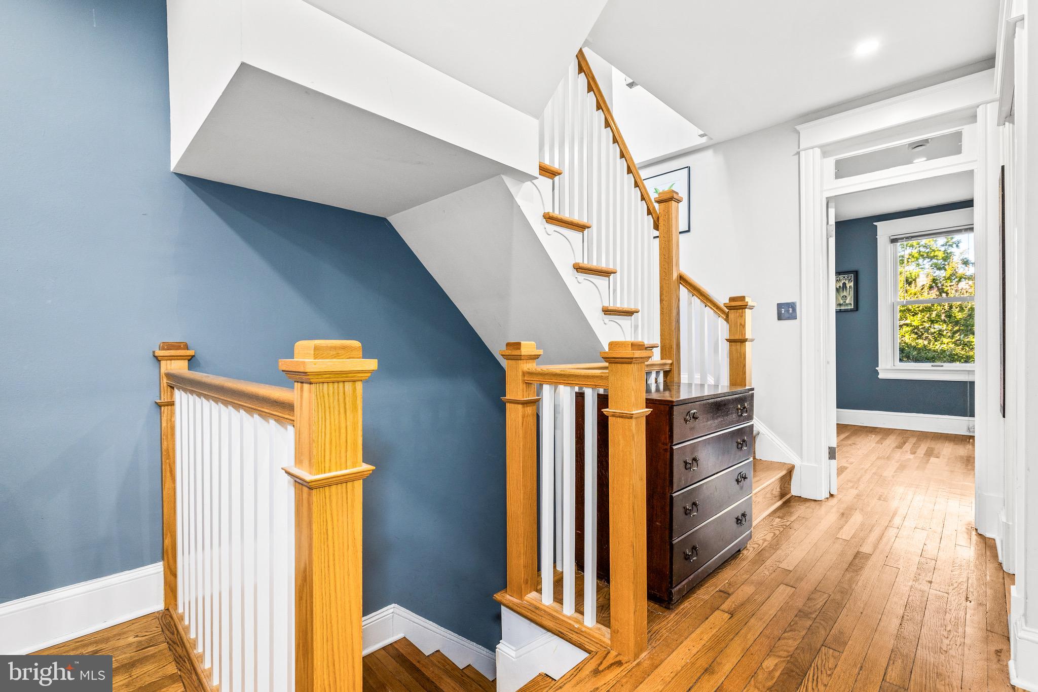 1716 Irving Street Northwest Washington, DC 20010 - Photo 15 of 43 a view of a hallway with wooden floor and staircase