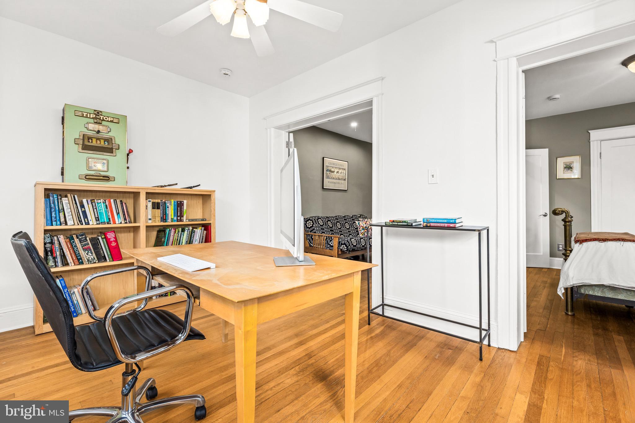 1716 Irving Street Northwest Washington, DC 20010 - Photo 21 of 43 a view of a workspace with furniture and wooden floor