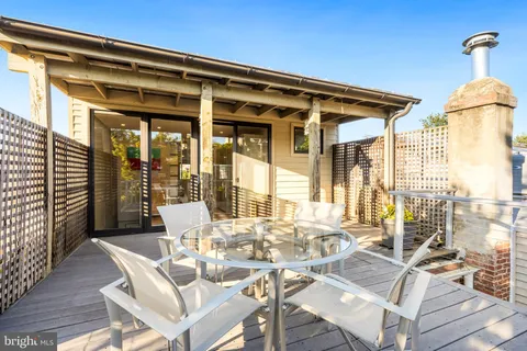 a view of a patio with table and chairs and potted plants