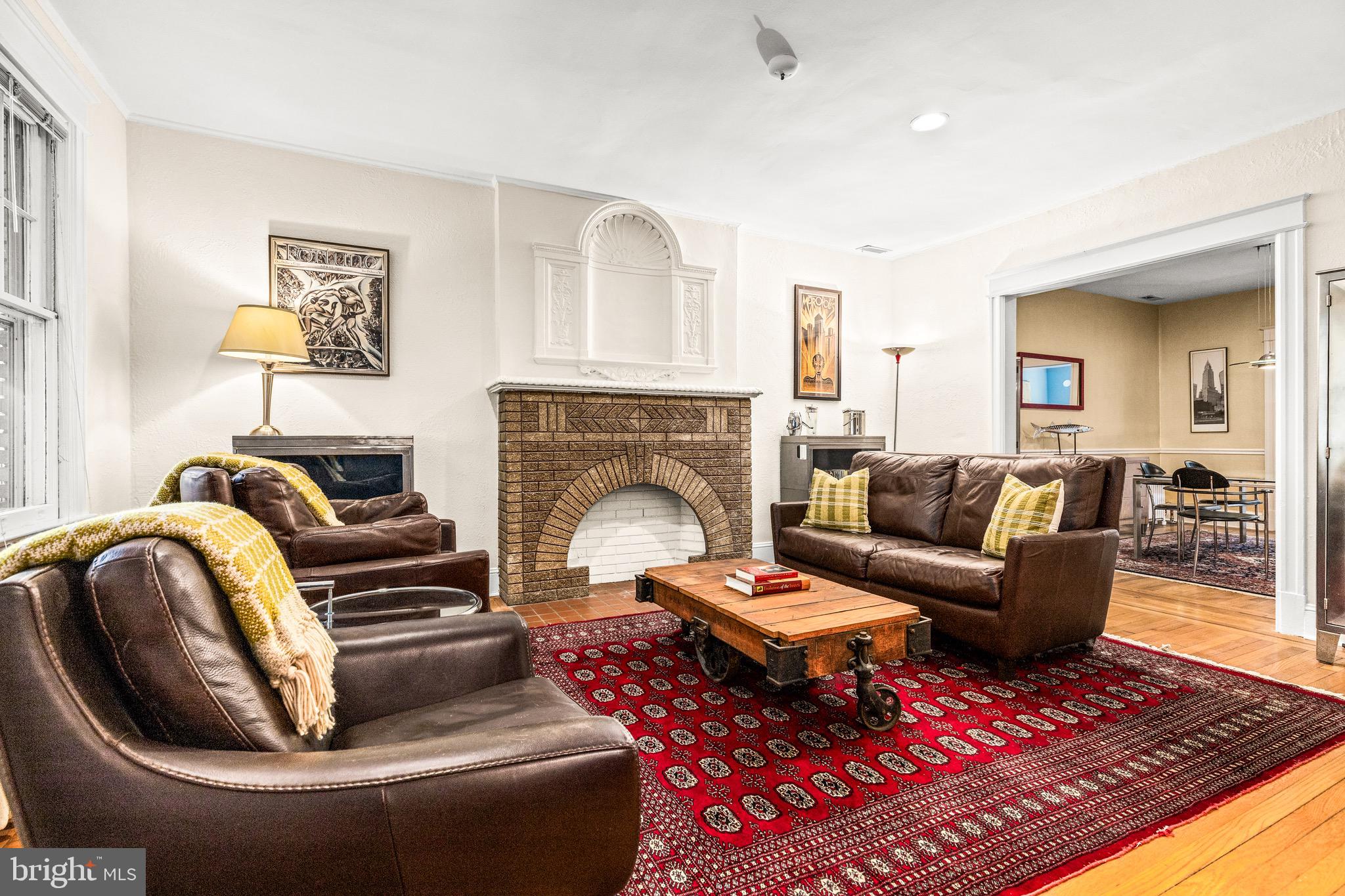 1716 Irving Street Northwest Washington, DC 20010 - Photo 5 of 43 a living room with furniture and a fireplace