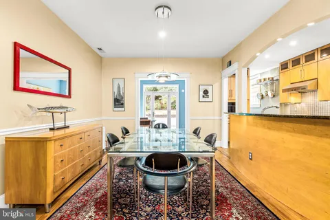 a spacious bathroom with a granite countertop sink a large mirror and a toilet