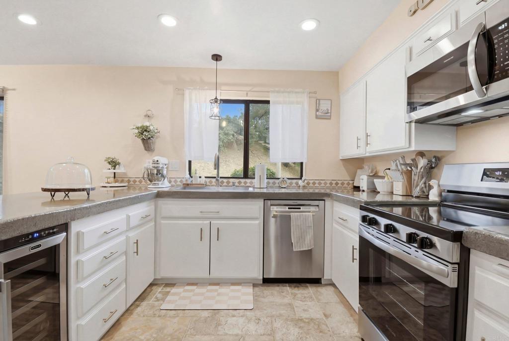 1988 Arnold Way Alpine, CA 91901 - Photo 8 of 22 a kitchen with stainless steel appliances granite countertop a sink and cabinets