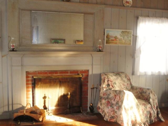 61 Lawrence Road Dennis Port, MA 02639 - Photo 1 of 14 a living room with furniture and a fireplace