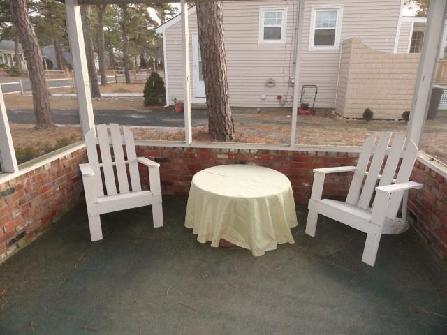 61 Lawrence Road Dennis Port, MA 02639 - Photo 12 of 14 a view of a patio with a table and chairs